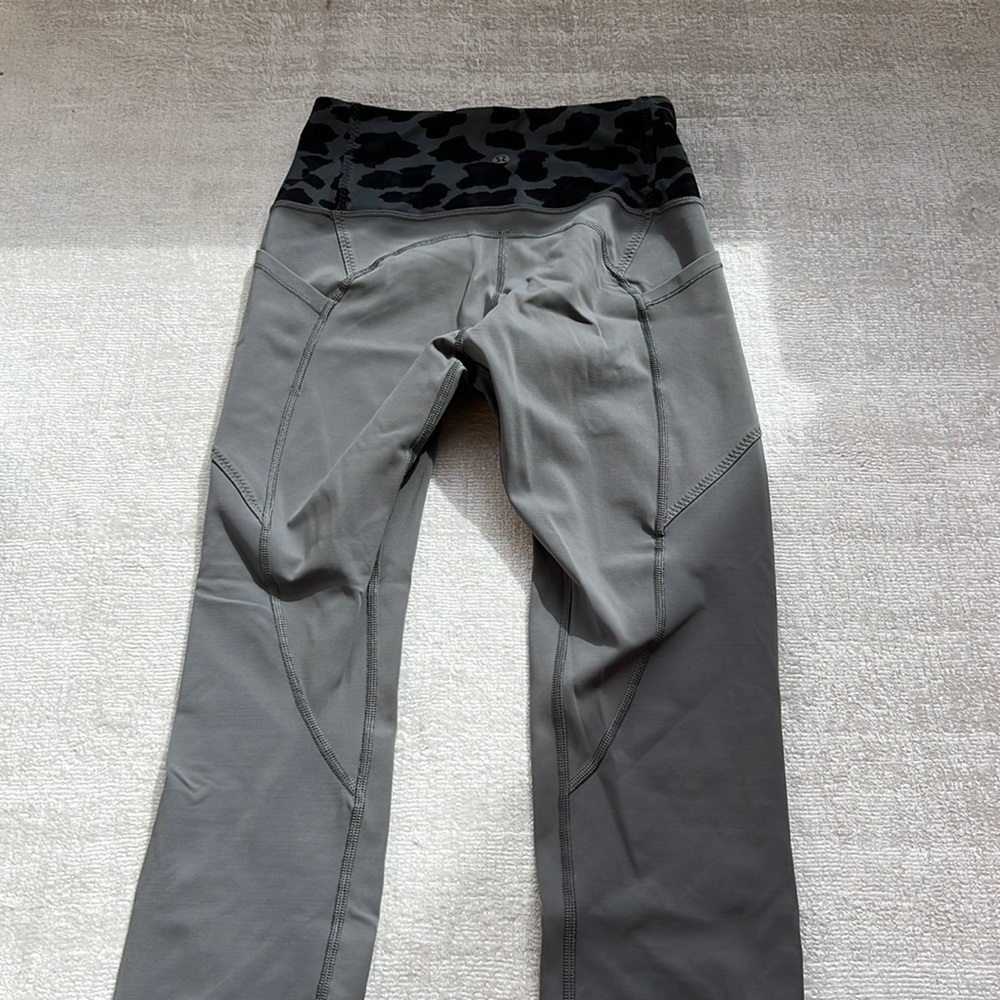 Grey Lululemon leggings with camo waistband and side pockets